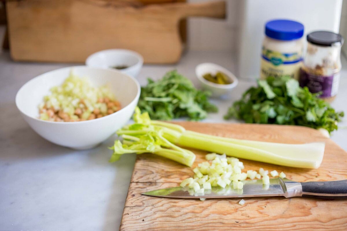 sharp knife and cutting board with minced celery.