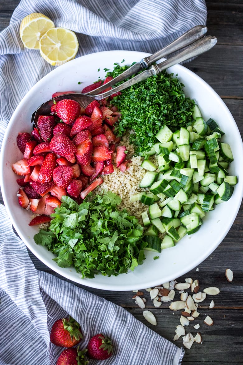 Delicious Strawberry Tabouli Salad - a twist on traditional tabouli, this spring-inspired version is made with quinoa, parsley, mint, and cucumber. Add avocado, toasted, slivered almonds, or feta if you like! #tabouli 