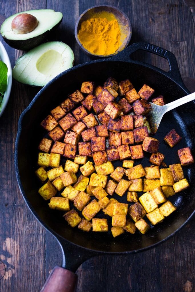 crispy cubes of tofu in a cast iron skillet. 