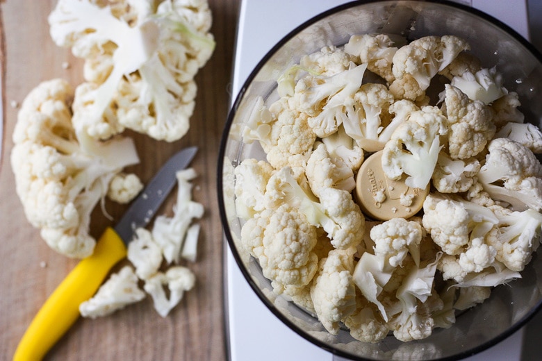cauliflower is cut into chunks and processed in a food processor.
