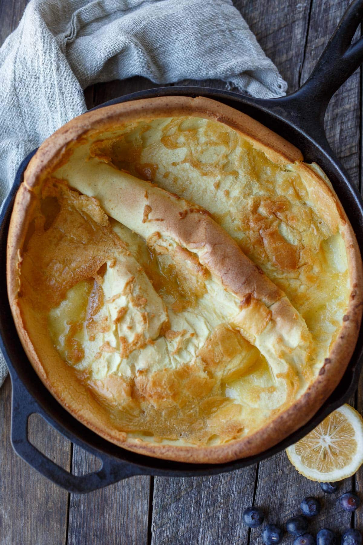 fluffy dutch baby cooked in cast iron skillet. 