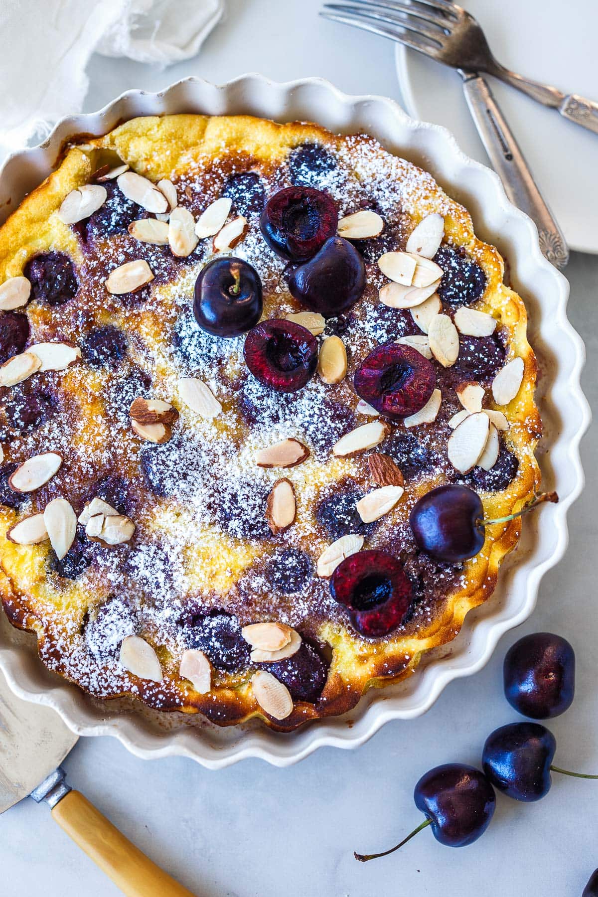 A classic French dessert, this easy Cherry Clafoutis recipe combines ripe cherries with a tender simple batter for a delightful treat. Perfect for any occasion, it impresses with its delicate custardy texture and sweet, tart flavor. Gluten-free adaptable.