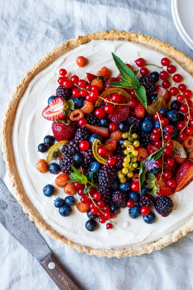 This creamy Vegan Berry Tart is perfect for summer entertaining! Made with lemony vanilla filling and gluten-free almond crust, topped with fresh summer berries.