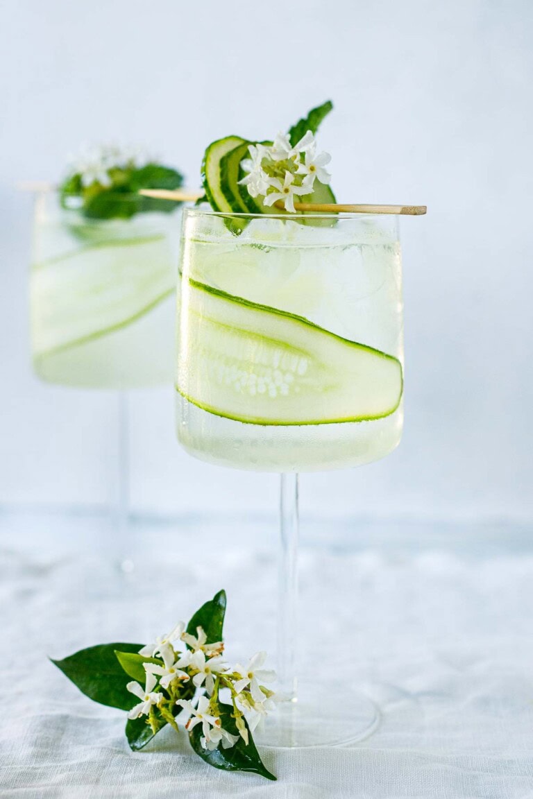 This white linen cocktail is perfect for summer! Crisp, clean flavors paired with cucumber, fresh lemon, and a hint of floral make this summer sipper one of our favorites!